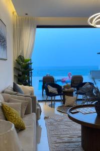 a living room with couches and a view of the ocean at Ocean pearl in Sharm