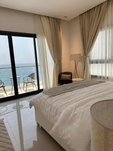 a bedroom with a bed and a view of the ocean at Ocean pearl in Sharm