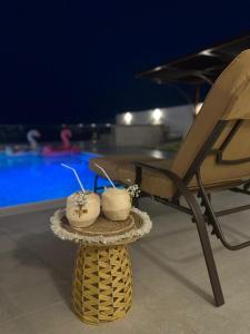 a chair and two candles on a table next to a pool at Ocean pearl in Sharm