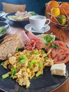 a plate of food with eggs and bread and toast at Mąka i Magia Obiady domowe Hotel in Zambrów