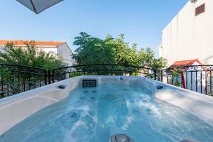 a hot tub on top of a balcony at Home with a unique view in Preko