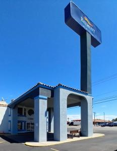 a gas station with a blue sign in front of it at Baymont by Wyndham Kingman in Kingman