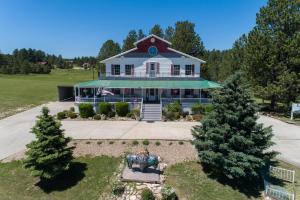 an aerial view of a white house with a porch at Eagle’s Landing Lodge in Custer