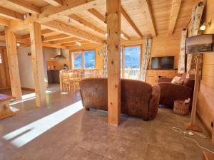 a living room and kitchen in a log house at Chalet typique, 4 chambres, vue montagne, WIFI, parking - FR-1-505-66 in Notre-Dame-de-Bellecombe