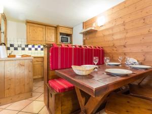 a kitchen with a wooden table with wine glasses at Appartement Les Arcs 1800, 3 pièces, 6 personnes - FR-1-346-348 in Arc 1800