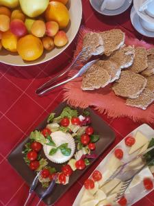 a table topped with plates of food with bread and fruit at Agriturismo Cascina Cipressa in San Romano