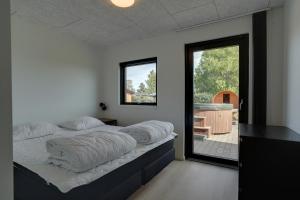 a bedroom with two beds and a large window at 9 Rooms Amazing Sommerhouse in Børkop