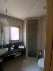 a bathroom with a toilet and a sink and a shower at Marrakech - Prestigia Golf - haut standing in Marrakesh