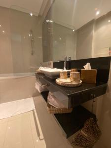 a bathroom with a sink and a mirror at Marrakech - Prestigia Golf - haut standing in Marrakesh