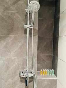 a shower with a shower head in a bathroom at The Axon Suites Bukit Bintang By Cozy Stay in Kuala Lumpur