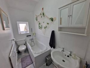a bathroom with a sink and a toilet and a bath tub at 4 bed charming, Family-friendly cottage 1694 in Rossendale
