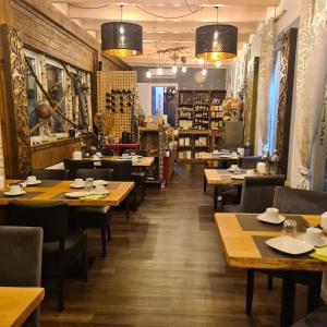 a restaurant with wooden tables and chairs in a room at Hotel Nacht-Quartier in Willich