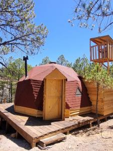a building with a wooden door and a wooden platform at Glamping Town in Otinapa +14 photos