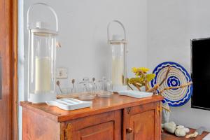 a wooden table with two glass vases on top of it at La casa di Fra' in Porto Rotondo