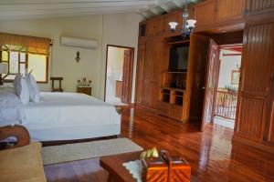 a bedroom with a bed and a television in it at FINCA EL PATRIARCA in Armenia +35 photos