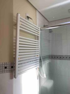 a bathroom with a shower and a window with a shutter at No Centro de Gramado bem pertinho do Natal Luz 77 in Gramado