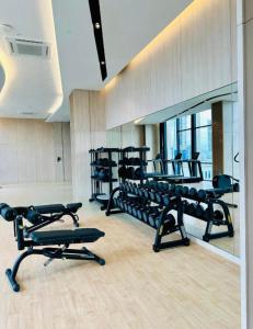 a gym with several rows of exercise equipment in a room at The Axon Suites Bukit Bintang By Cozy Stay in Kuala Lumpur