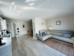 a living room with a couch and a kitchen at Beside the sea & minutes from Cliffs-Clahane Shore Lodge in Liscannor