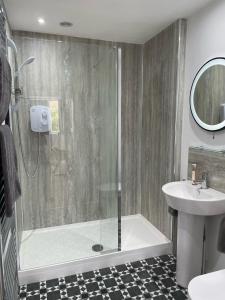 a bathroom with a shower and a sink at Watts Lodge in Bicester