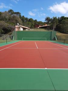 a tennis court with a tennis racket on it at Chácara linda em condomínio rural - Sousas in Campinas