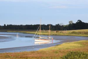 a sailboat sitting in the water on a river at River View in Aldeburgh