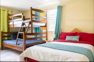 a bedroom with a bunk bed and a bunk ladder at Espléndida y Acogedora Villa con Vista a las Montañas y Nuestro Bello Pueblo in Jarabacoa