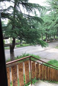 a wooden fence with a tree in the background at Apartment in Dilijan in Dilijan