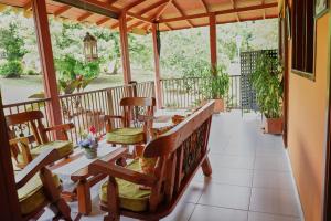 a porch with a table and chairs on it at FINCA EL PATRIARCA in Armenia