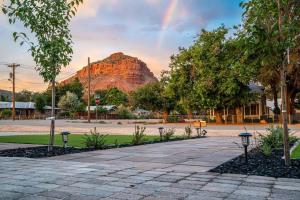 a view of a mountain with a rainbow in the sky at Rustic Gold Retreat in Kanab