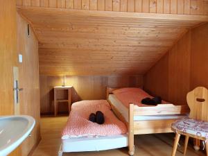 a bedroom with a bed and a tub in a room at Chant du Torrent: 12 pers. idéal pour les familles in Nendaz