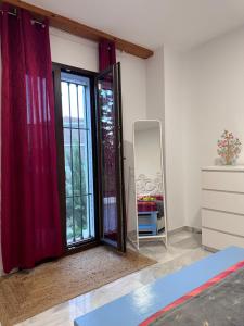 a room with a sliding glass door and a mirror at Apartamento Cortijo Pontiví in Salobreña +22 photos