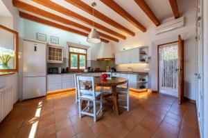 a kitchen with a table and chairs in a room at Sa Finqueta, Luxury Elegant Mansion with breathtaking views of Soller in Sóller