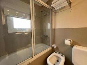 a bathroom with a shower and a toilet and a sink at Vista al Mar in Puerto Madryn