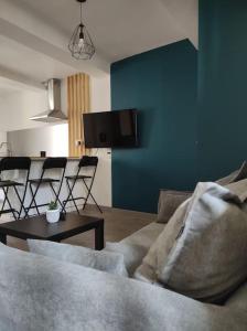 a living room with a couch and a table with chairs at Maison de village avec exterieur in Lambesc