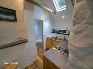a kitchen with a counter and a stove top oven at the anchor light in Pembroke