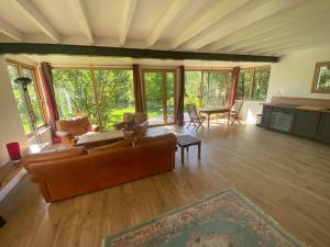a living room with a couch and a table at Apatam-Montigny, bord du Loing in Bourron-Marlotte