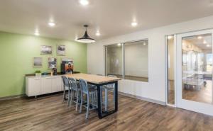 a kitchen and dining room with a table and chairs at WoodSpring Suites Ashland - Richmond North in Ashland
