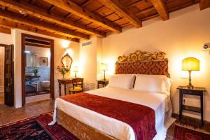 a bedroom with a large bed and a bathroom at Villa Carrara La Spada in Grezzana