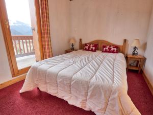a bedroom with a large bed and a balcony at Duplex 4 chambres avec piscine et parking au centre du village - 10 pers - FR-1-505-122 in Notre-Dame-de-Bellecombe +14 photos