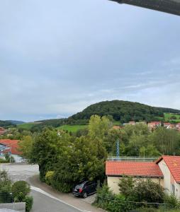 a view of a town with a mountain in the background at Hochwaldblick in Glan-Münchweiler