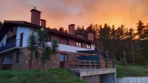 a house with a sunset in the background at Caserío Ea in Ea