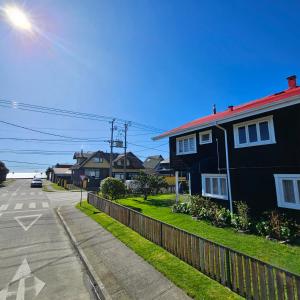 a row of houses on the side of a street at Casa Ellies Hotel Boutique in Puerto Varas