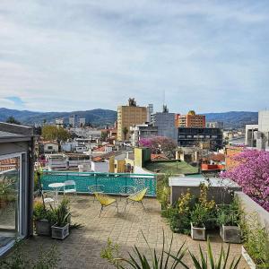 a balcony with chairs and a view of a city at CASA MARGARITA 5Piso Mono Verde Oscuro in San Salvador de Jujuy