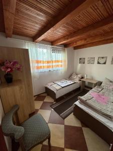 ein Zimmer mit 2 Betten und einem Stuhl darin in der Unterkunft Domki Pod Brzoza in Idzików