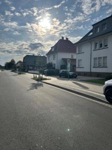 a street with houses and a car parked on the road at Schöner Wohnen in Bünde in Bünde