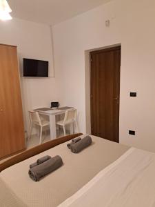 a bedroom with a bed with two towels on it at La Foggia seaside paradise in Siculiana