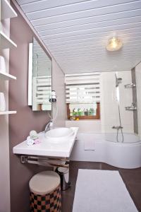 een badkamer met een wastafel, een toilet en een bad bij Ferienwohnung Deubzer in Palling in Palling