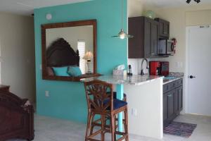 a kitchen with a counter and a chair in a room at Boot Key Harbor Penthouse in Marathon