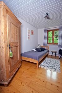 een slaapkamer met een bed en een houten deur bij Ferienwohnung Deubzer in Palling in Palling