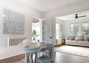 a kitchen and living room with a table and chairs at Surfside Oasis Walk to beach in Asbury Park